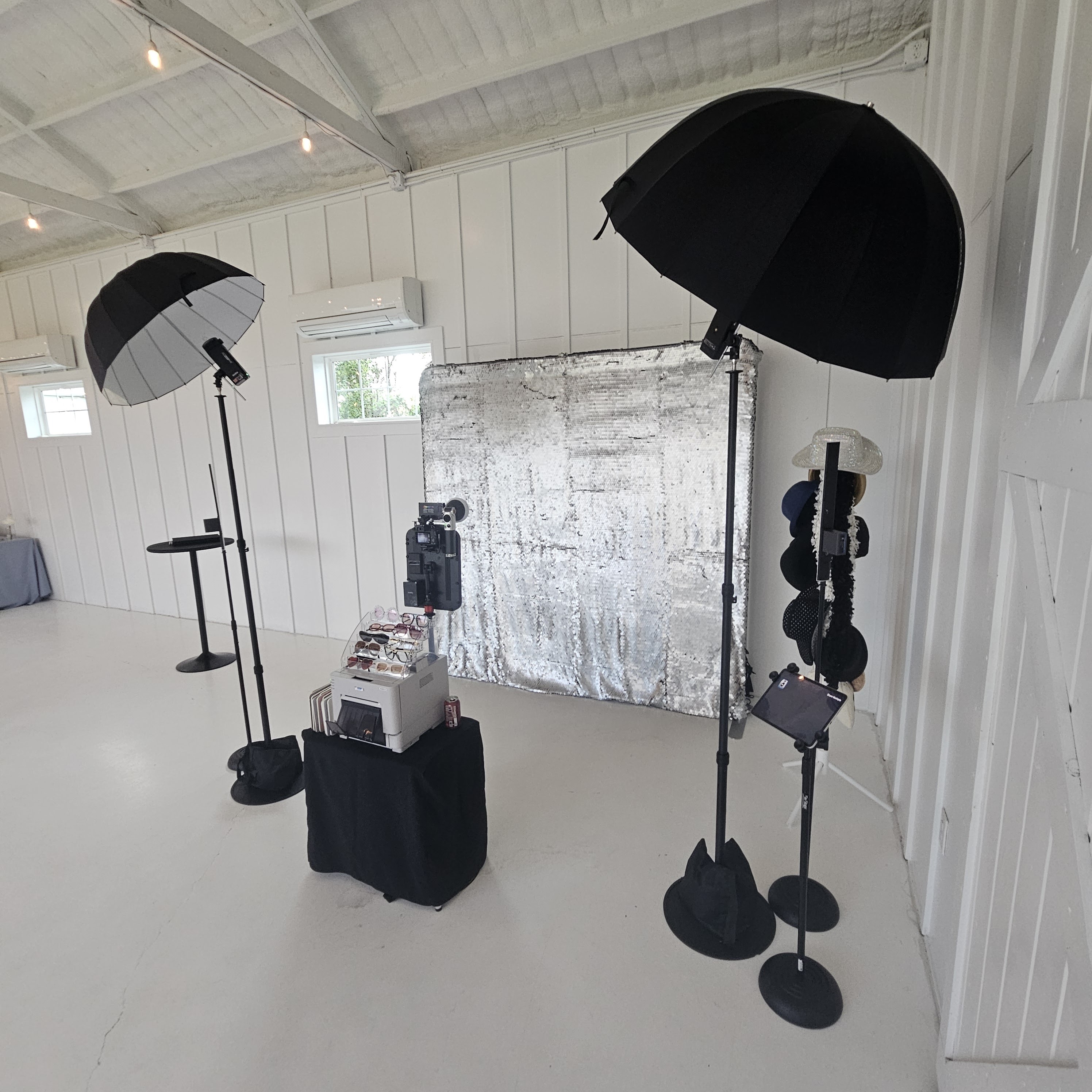 Studio Booth setup with a silver sequin backdrop, lighting, printer and sharing tablet